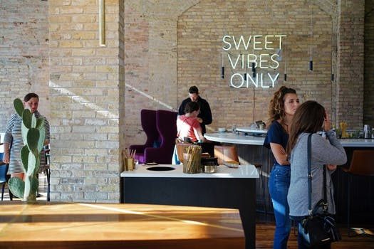 Sweet Vibes Only sign in office with people