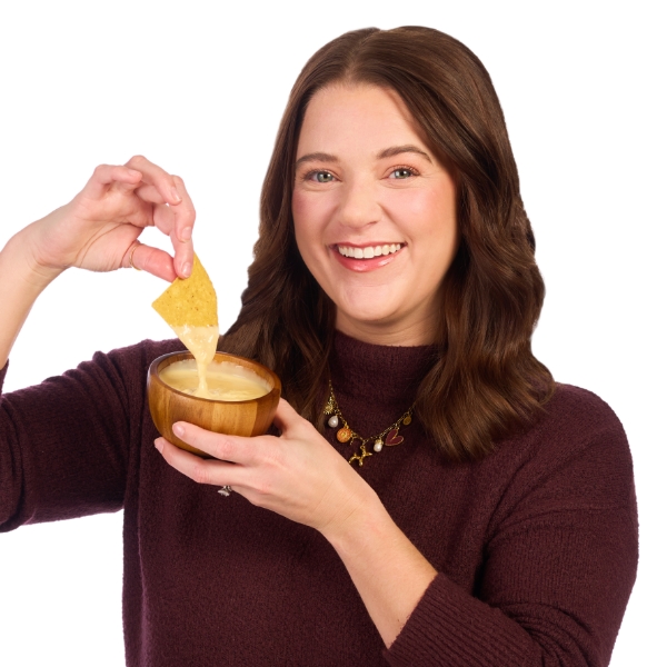 Jenn dipping a tortilla chip into a bowl of queso