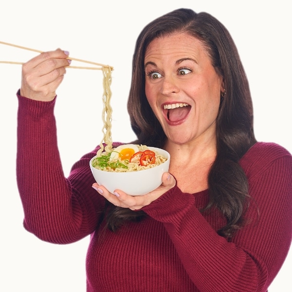 Anna using chopsticks with ramen noodles