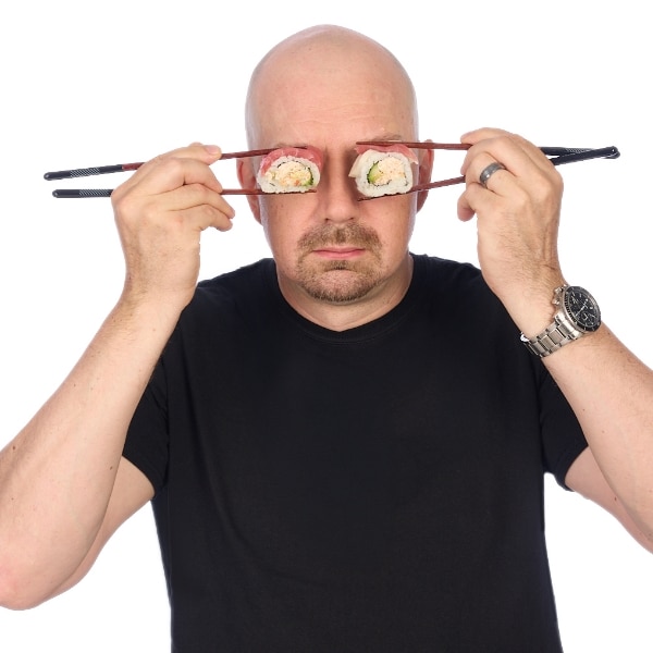 Brian holding sushi pieces