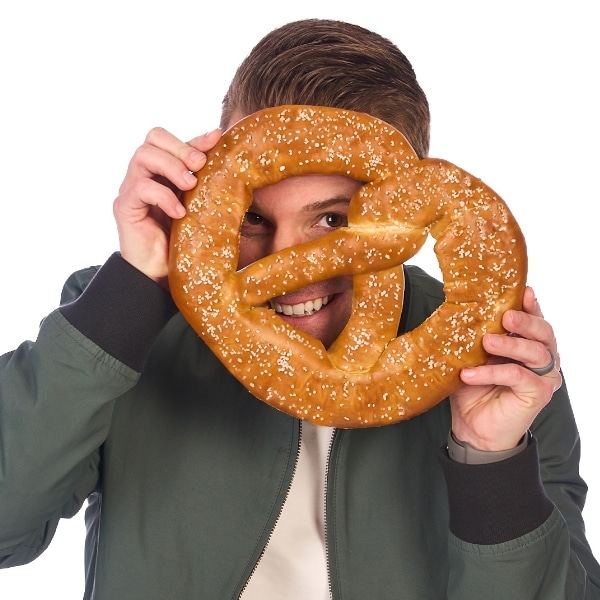 Justin looking through a giant soft pretzel