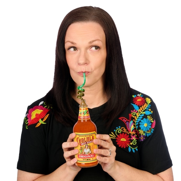 Lizzie drinking a bottle of hot sauce