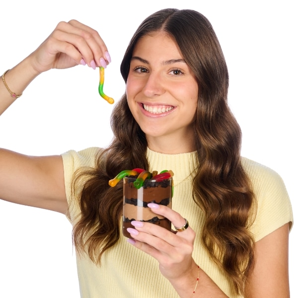 Lindsay holding a dirt and worms pudding cup